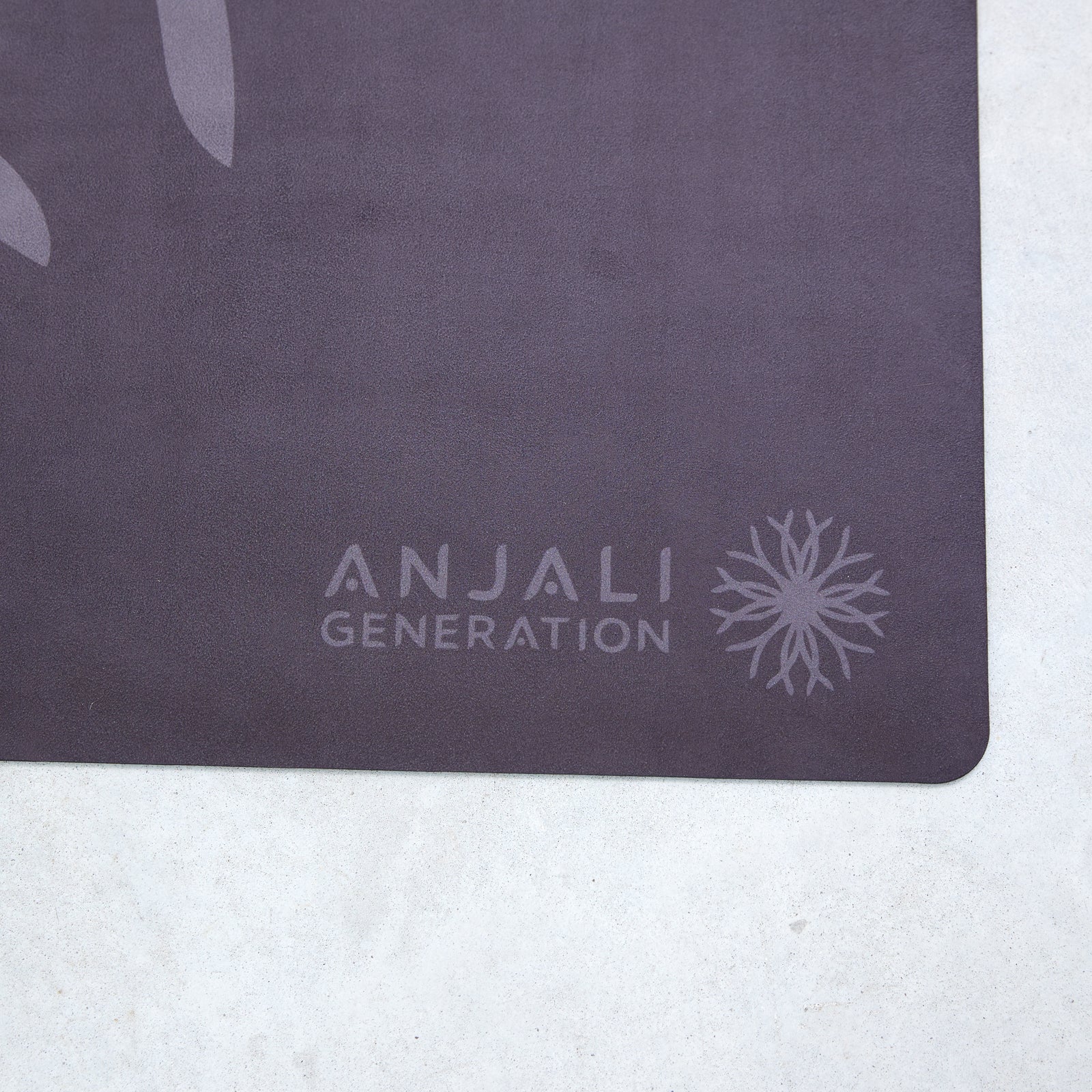 Dark gray Anjali Generation eco suede yoga mat with on a light gray background