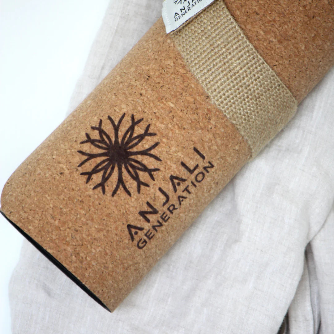 Cork yoga mat with 'Anjali Generation' branding on a white background