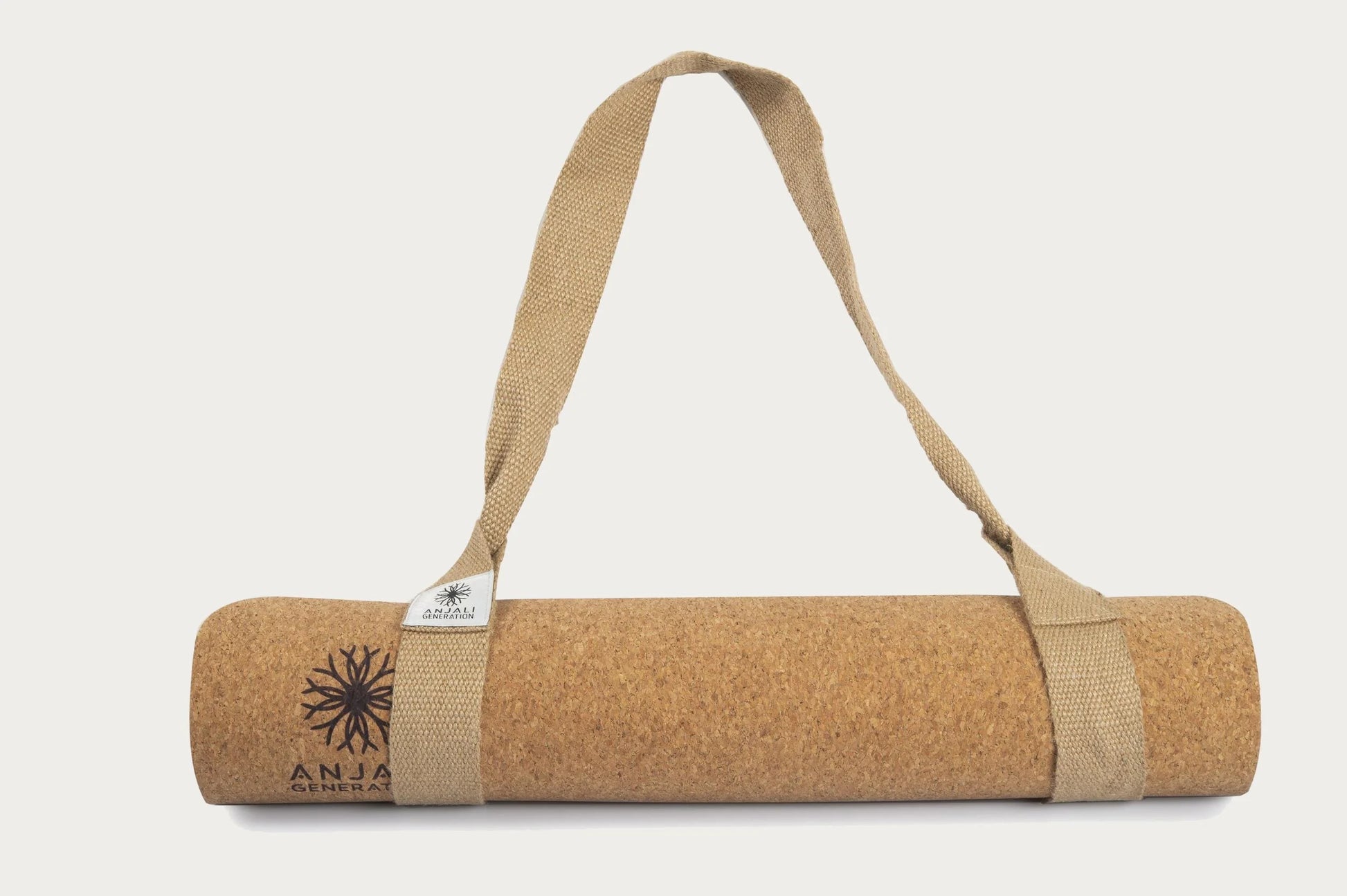 Anjali Generation luxury cork yoga mat with a carrying strap on a white background