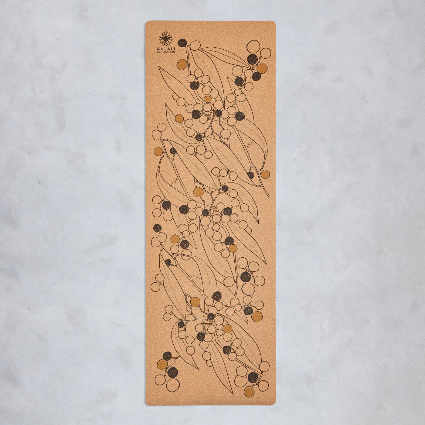 Anjali Generation cork yoga mat with wattle floral design on a light gray background
