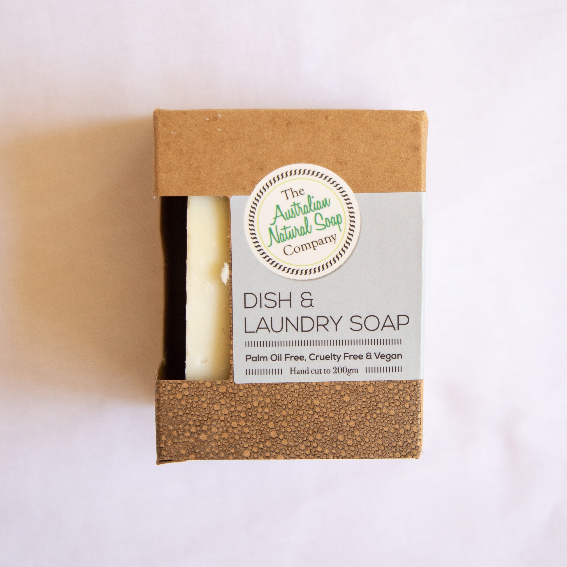 Australian Natural Soap Company Dish and laundry soap bar in a brown packaging with a label on a white background
