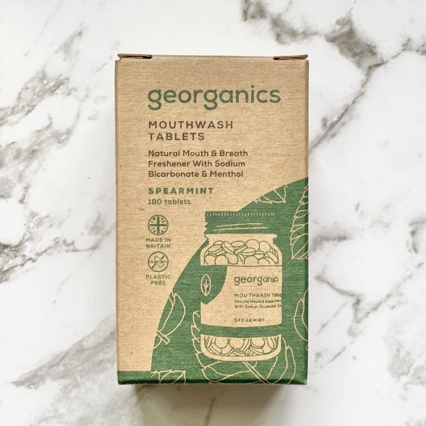 Georganics spearmint mouthwash tablets packaging on a marble surface