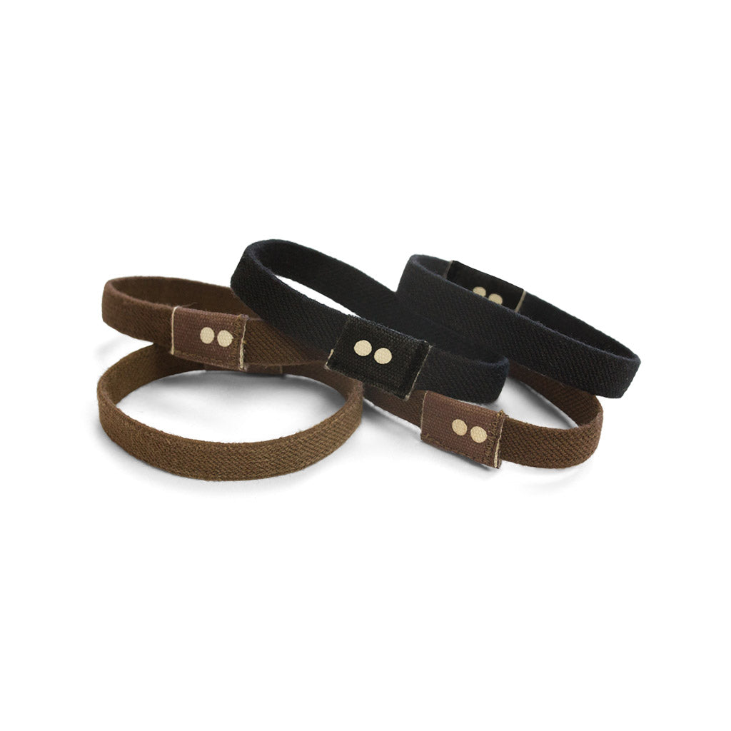 Kooshoo organic hair ties in brown and  black on a white background