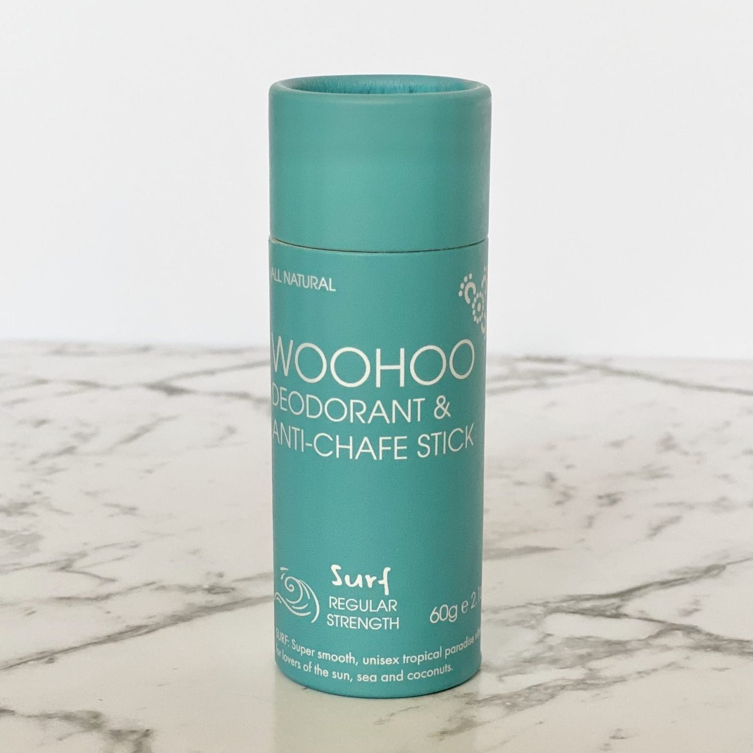 Woohoo Body deodorant stick in blue cardboard tube packaging on a marble surface
