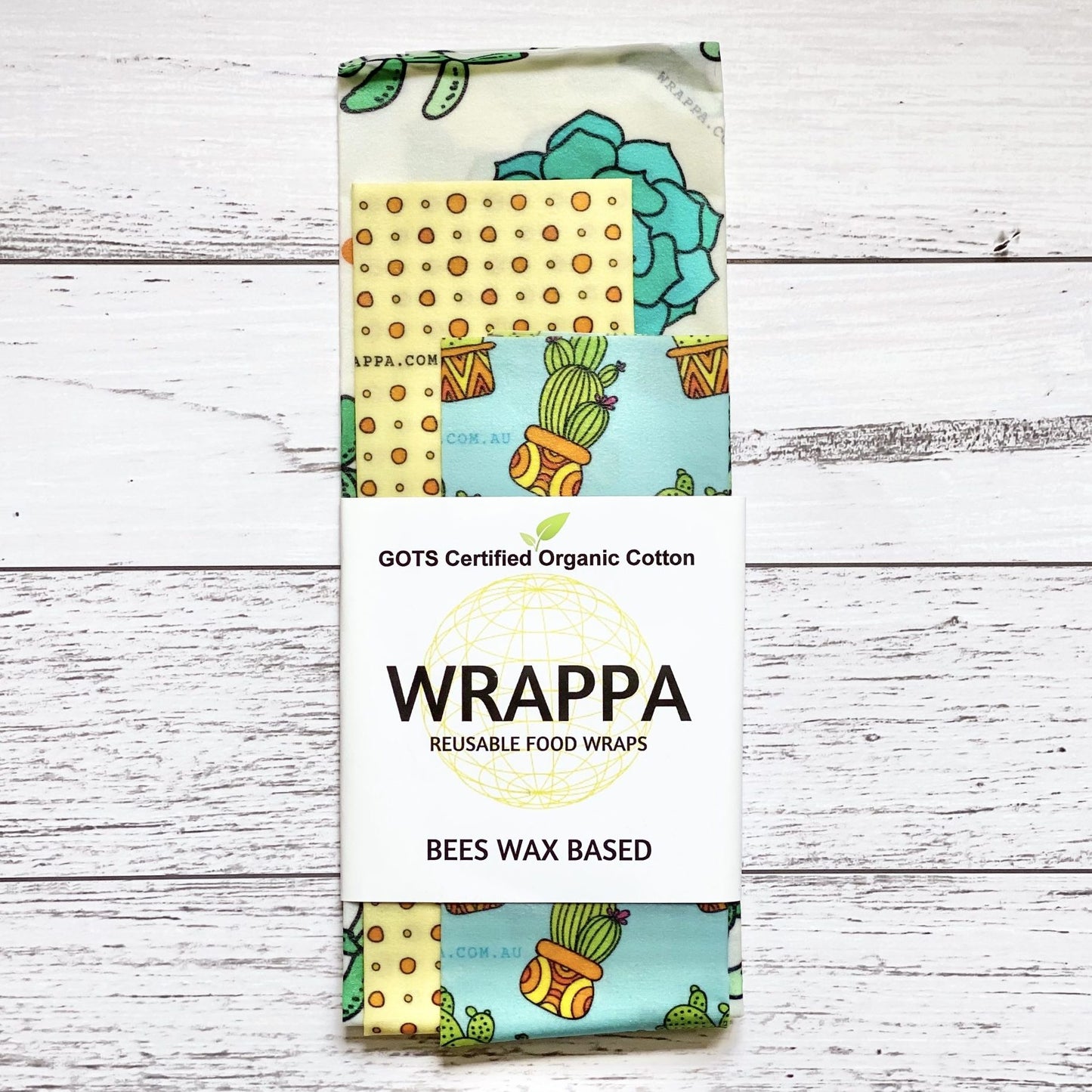Pack of WRAPPA reusable beeswax food wraps with various patterns on a wooden surface
