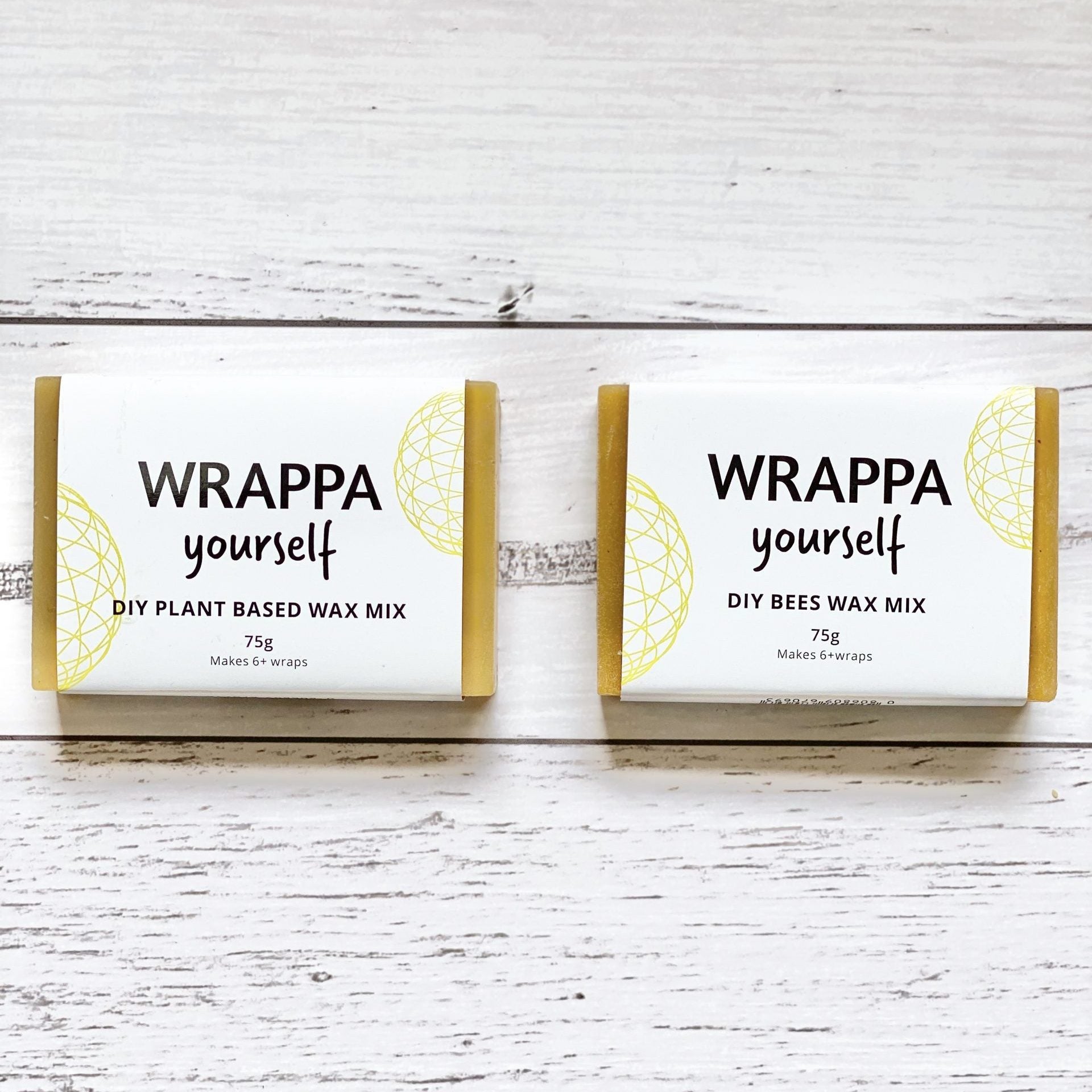 Two blocks of WRAPPA yourself DIY wax in plant-based and beeswax, on a wooden surface
