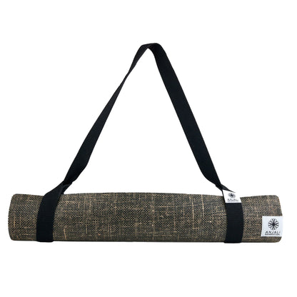 Yoga mat with black strap and visible Anjali Generation brand logo on a white background