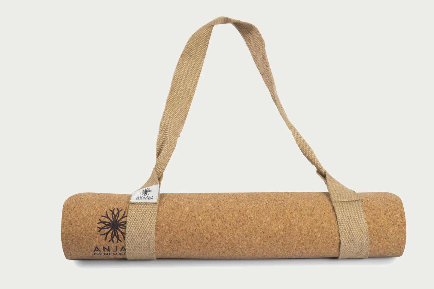 Anjali Generation luxury cork yoga mat with a carrying strap on a white background