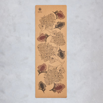 Anjali Generation cork yoga mat with grevillea floral design on a light gray background