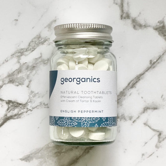 Jar of Georganics English peppermint natural tooth tablets on a marble surface