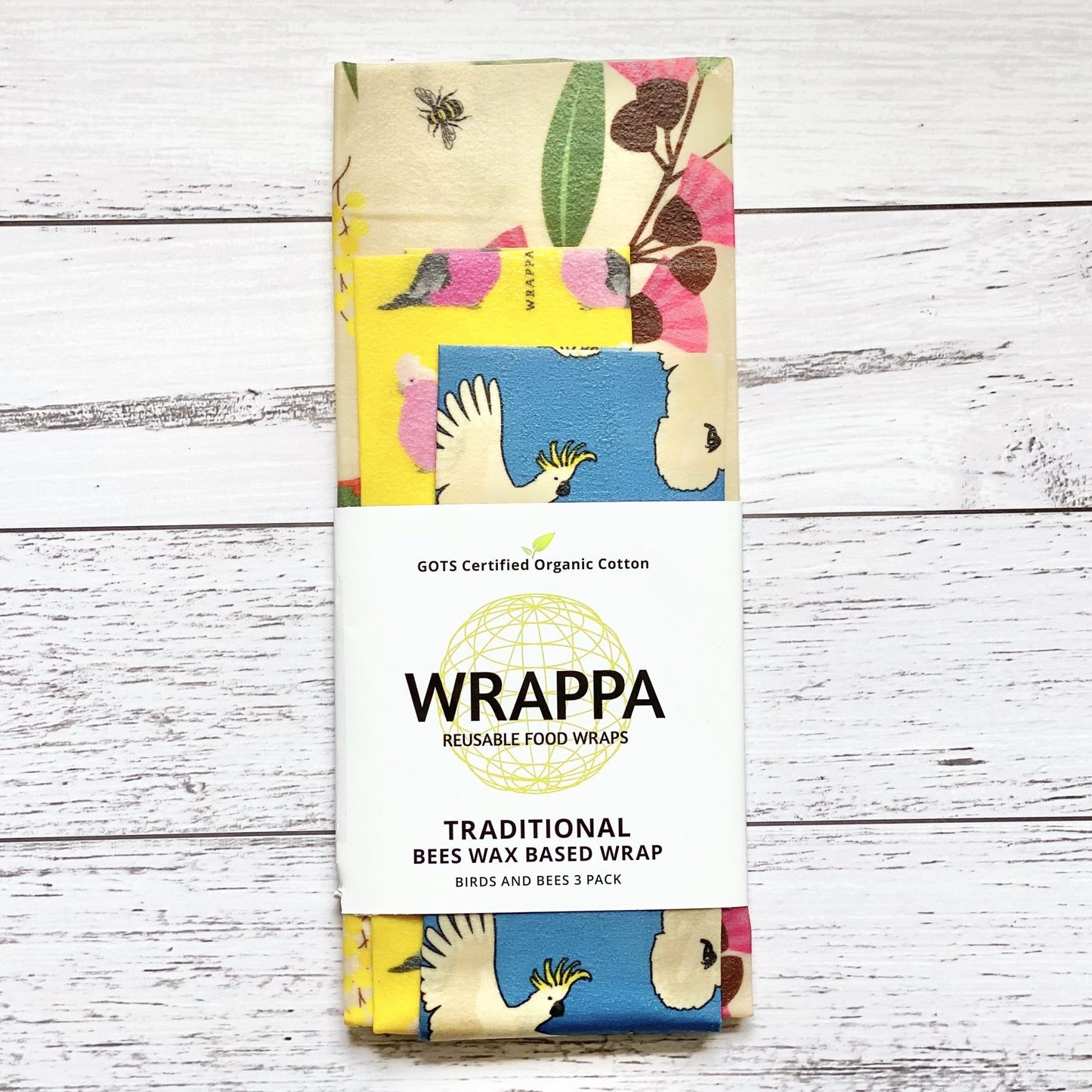 Pack of WRAPPA reusable beeswax food wraps with colourful design on a wooden surface
