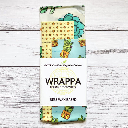 Pack of WRAPPA reusable beeswax food wraps with various patterns on a wooden surface