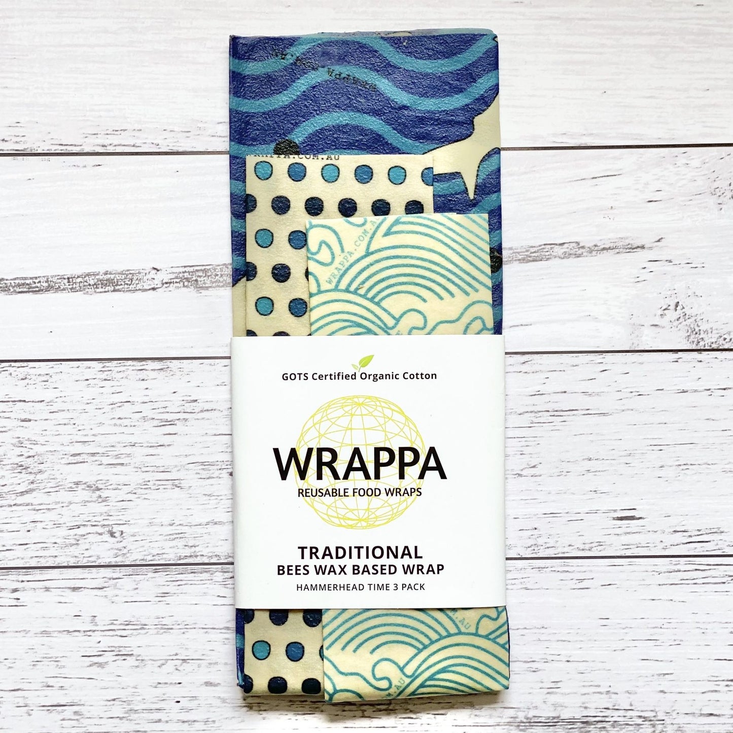 Pack of WRAPPA reusable beeswax food wraps with patterned designs on a wooden surface