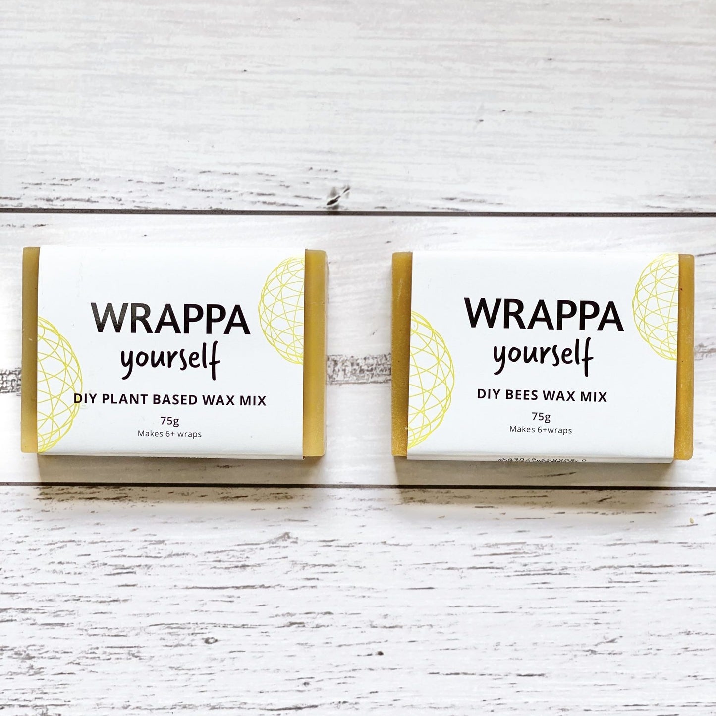 Two blocks of WRAPPA yourself DIY wax in plant-based and beeswax, on a wooden surface