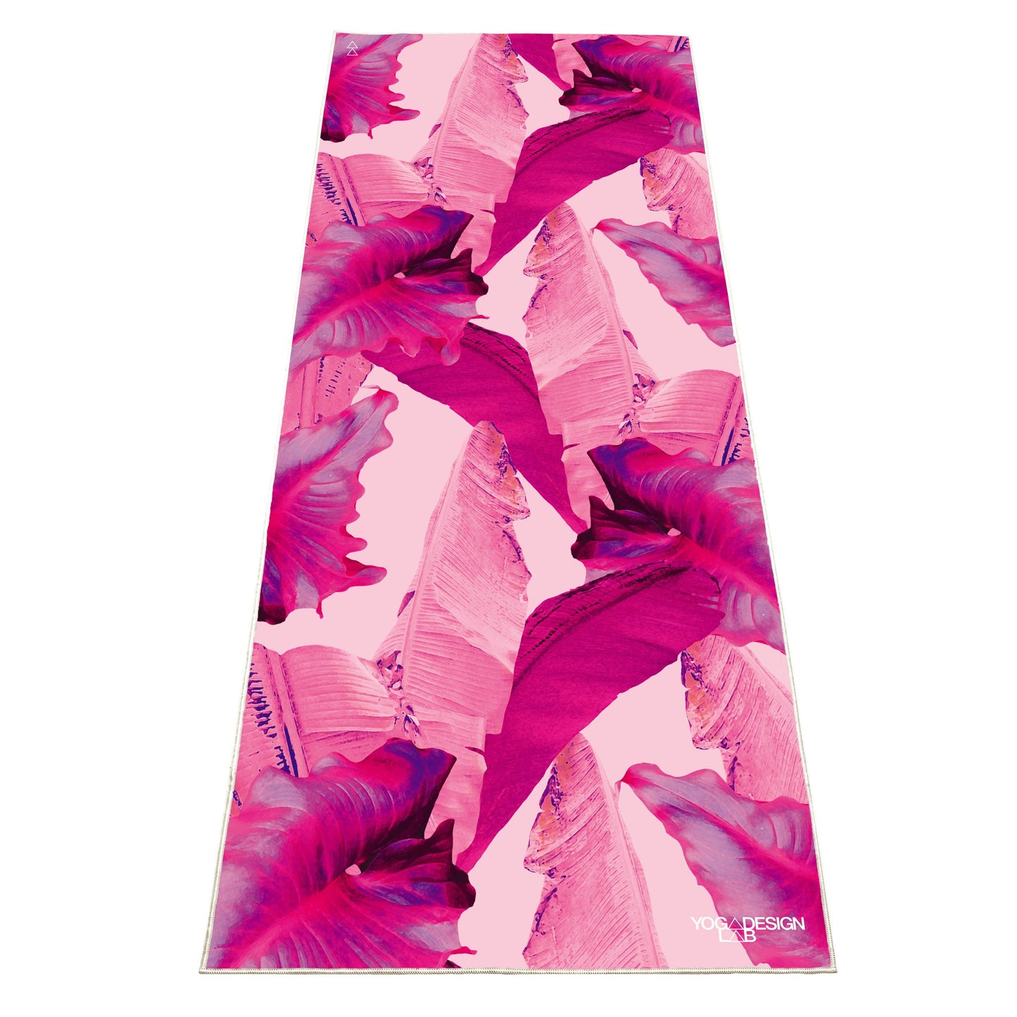 Pink and purple floral patterned Yoga Design Lab yoga mat towel on a white background