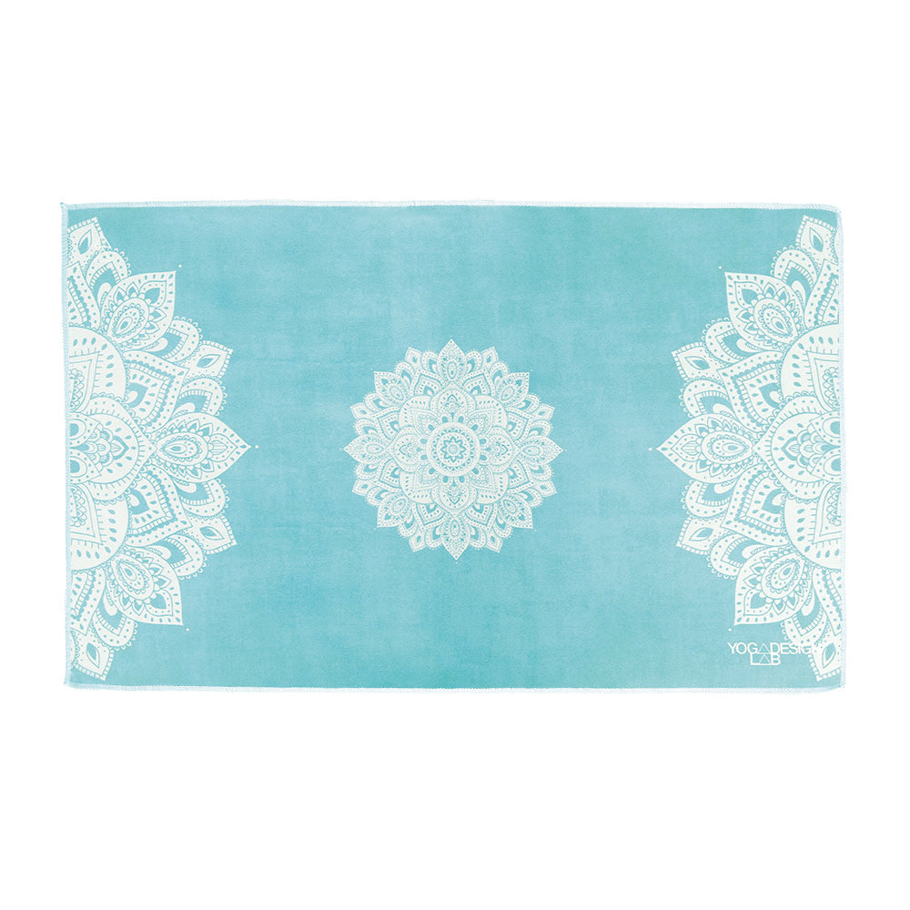 Yoga Design Lab Turquoise yoga hand towel with white mandala patterns on a white background